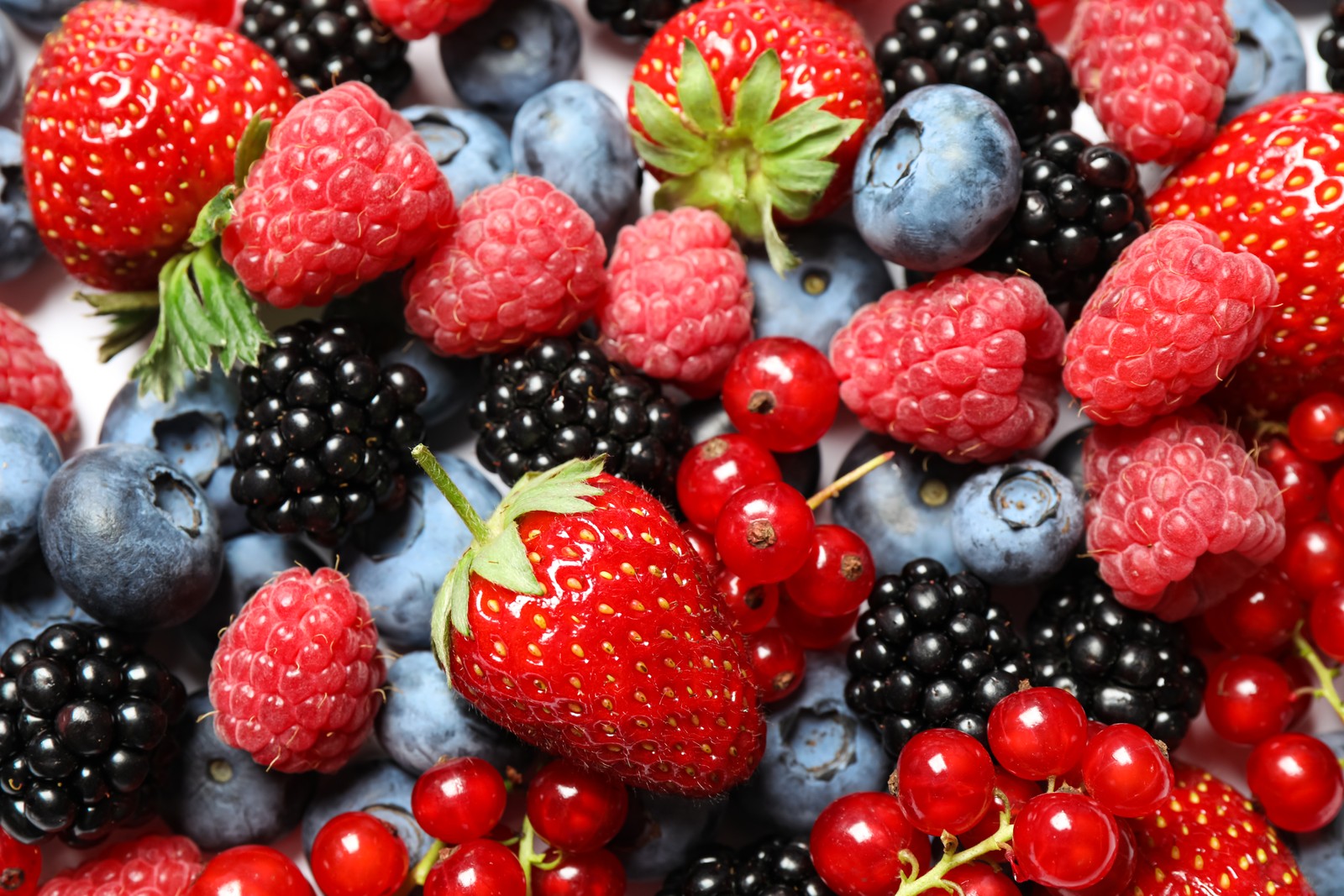 Photo of mix of fresh delicious berries as background, top view