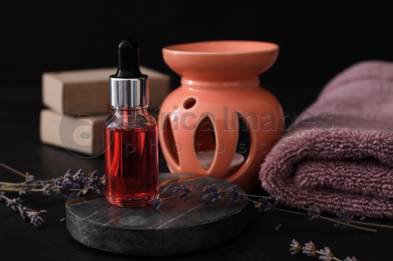 Lavender essential oil for aroma lamp on black table