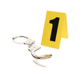 Handcuffs and crime scene marker with number one isolated on white