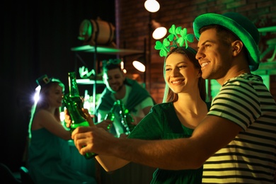 Couple with beer celebrating St Patrick's day in pub