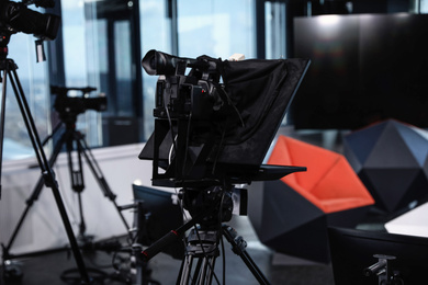 Modern video recording studio with professional equipment, focus on camera