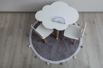 Small table and chairs in baby room, above view
