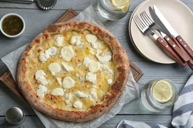 Tasty cheese pizza served on grey wooden table, flat lay