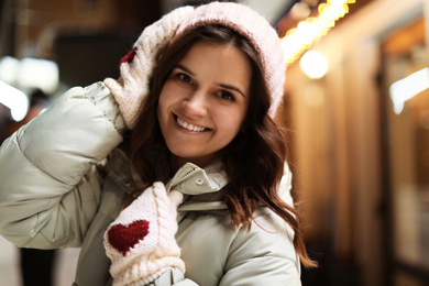 Beautiful young woman on city street. Winter vacation