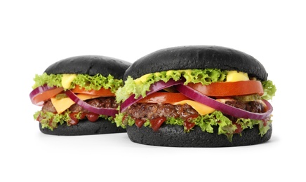 Photo of Tasty unusual black burgers isolated on white