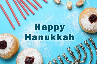 Happy Hanukkah. Traditional menorah, candles, sufganiyot and dreidels on light blue background, flat lay 