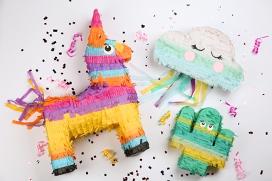 Photo of Different pinatas on white background, top view