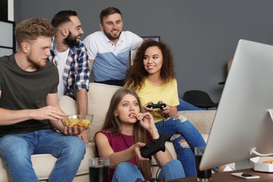 Emotional friends playing video games at home