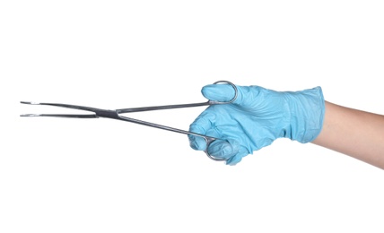 Doctor in sterile glove holding medical forceps on white background