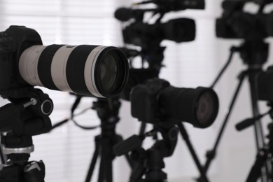 Modern video cameras indoors, closeup. Professional media equipment for broadcasting event