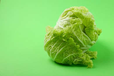 Photo of Fresh ripe Chinese cabbage on light green background, space for text
