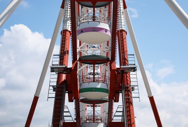 Beautiful large Ferris wheel against cloudy sky, closeup