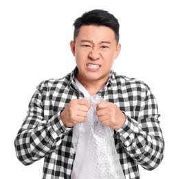 Photo of Emotional asian man with bubble wrap on white background