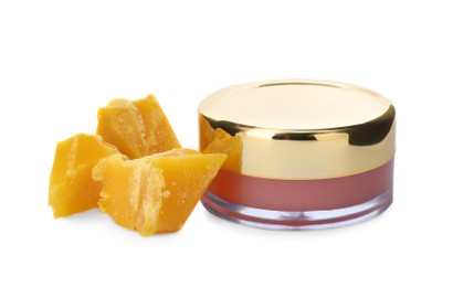 Lip balm and natural beeswax on white background