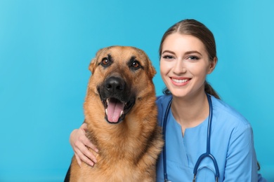 Veterinarian doc with dog on color background