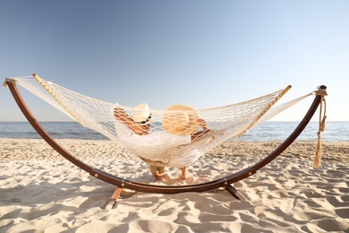 Couple. Summer vacation relaxing in hammock on beach