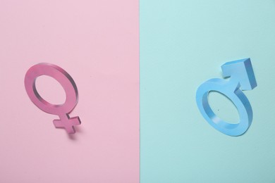 Photo of Gender pay gap. Male and female symbols on color background, flat lay