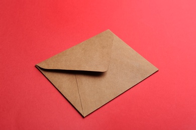 Brown paper envelope on red background. Mail service