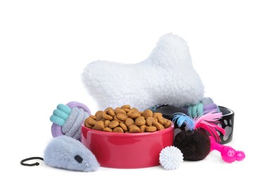Feeding bowls and toys for pet on white background