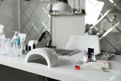 Professional equipment for manicure on table in beauty salon