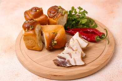 Photo of Delicious pampushky (buns with garlic), salo, peppers and parsley on color textured table