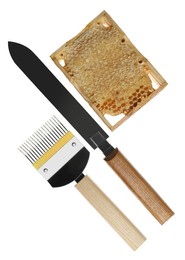Beekeeping tools and hive frame with honeycomb on white background, top view