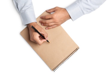 Man with pen and notepad on white background, top view. Closeup of hands