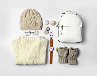 Stylish female autumn outfit and accessories on white background, flat lay. Trendy warm clothes