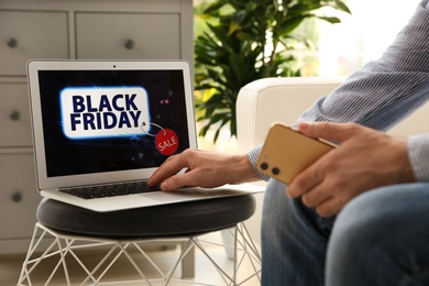 Man shopping online using laptop at home, closeup. Black Friday Sale