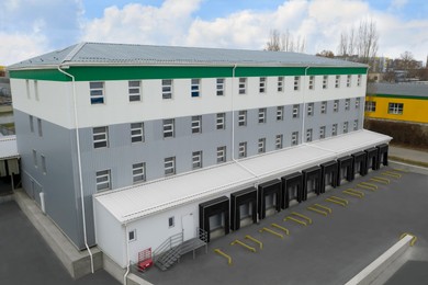 Warehouse with loading docks outdoors, aerial view. Logistics center