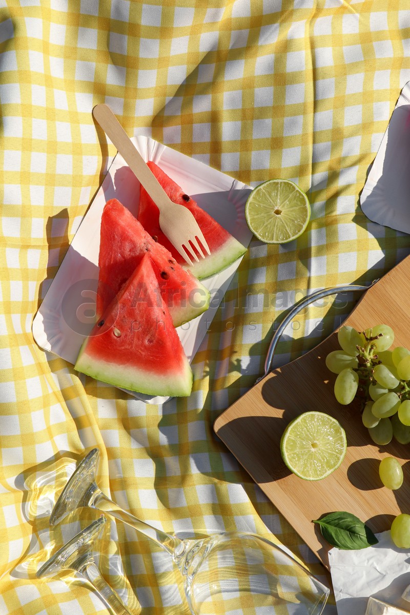 Delicious watermelon and fruits on picnic blanket, flat lay