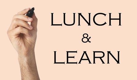 Lunch and Learn concept. Man with marker on beige background, closeup