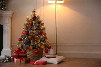 Beautiful Christmas tree and gift boxes in room. Space for text