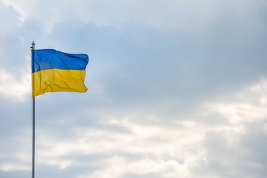 National flag of Ukraine against cloudy sky