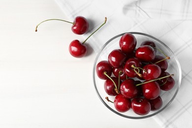 Sweet red cherries on white wooden table, flat lay. Space for text