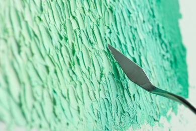 Abstract colorful artwork painting with spatula, closeup view