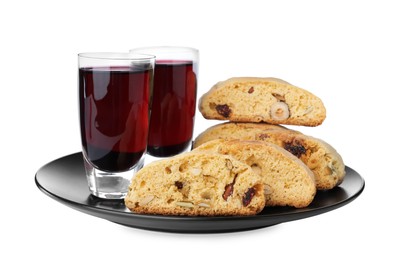 Plate with tasty cantucci and glasses of liqueur on white background. Traditional Italian almond biscuits