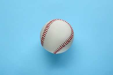 Photo of Baseball ball on light blue background, top view. Sports game