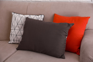 Colorful soft pillows on modern sofa in room