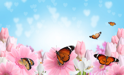 Beautiful blooming flowers and painted lady butterflies 