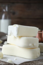 Photo of Delicious glazed ice cream bars on wooden table, closeup