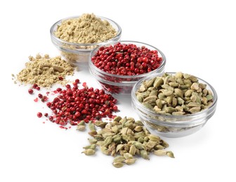 Photo of Bowls with dried cardamom, ginger root powder and red peppercorns on white background