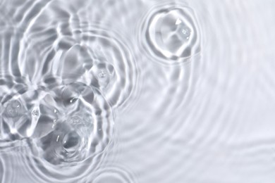 Closeup view of water with circles on light background