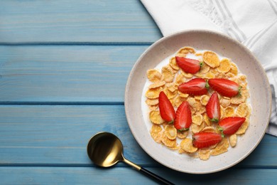 Photo of Delicious crispy cornflakes with milk and fresh strawberries on light blue wooden table, flat lay. Space for text