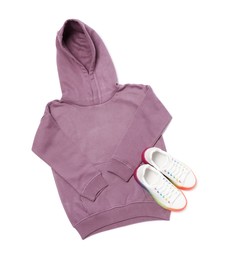 Photo of Violet hoodie and sport shoes on white background, top view
