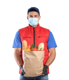 Courier in medical mask holding paper bag with food on white background. Delivery service during quarantine due to Covid-19 outbreak