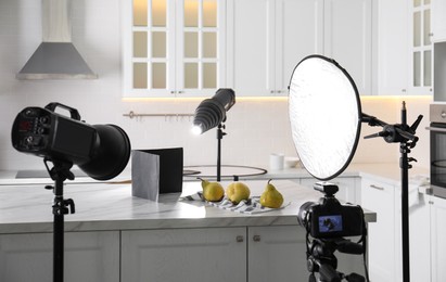 Photo of Professional equipment and many pears on table in kitchen. Food photo