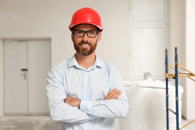 Portrait of professional engineer in hard hat indoors
