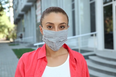 Woman wearing handmade cloth mask outdoors. Personal protective equipment during COVID-19 pandemic