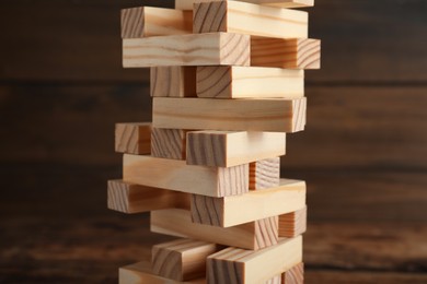 Jenga tower made of wooden blocks on table, closeup
